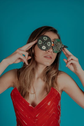 woman covering her eyes with circuit boards