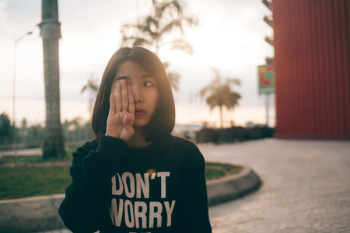 Woman Covering Her Right Eye Using Her Right Hand during Daytime