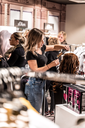 Woman Curling Another Woman's Hair Woman Curling Another Woman's Hair