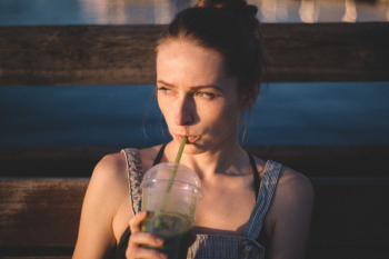 Woman Drinking Sipping on Plastic Cup