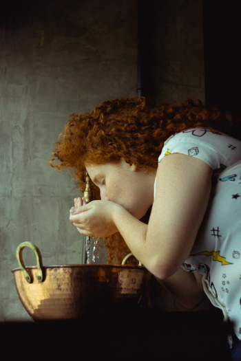 Woman Drinking Water From Faucet Woman Drinking Water From Faucet