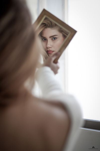 woman facing the mirror woman facing the mirror
