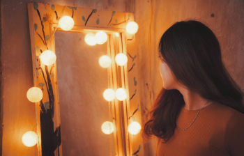 Woman Facing Vanity Mirror Woman Facing Vanity Mirror
