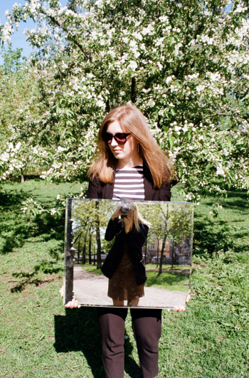 woman holding a mirror outdoors woman holding a mirror outdoors