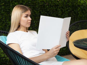 Woman holding a mock-up magazine Free Photo