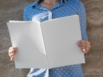 Woman holding a mock-up magazine Free Photo