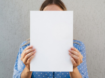 Woman holding a mock-up magazine Free Photo