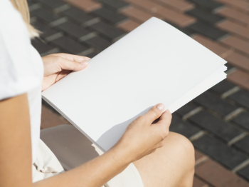 Woman holding a mock-up magazine Free Photo