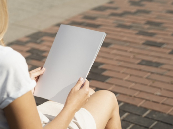 Woman holding a mock-up magazine Free Photo