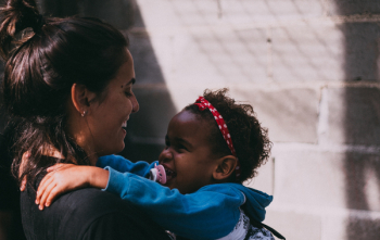 Woman Holding Baby Wearing Blue Jacket Woman Holding Baby Wearing Blue Jacket