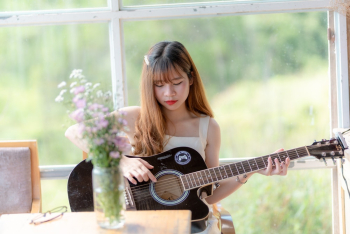 Woman Holding Black Acoustic Guitar Woman Holding Black Acoustic Guitar
