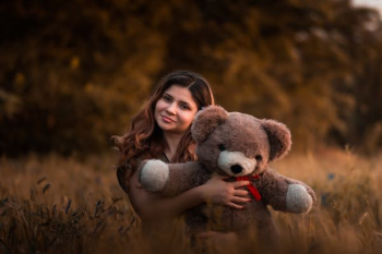 woman holding brown bear woman holding brown bear