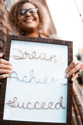 Woman Holding Brown Wooden Frame With Dream Achieve Succeed Woman Holding Brown Wooden Frame With Dream Achieve Succeed
