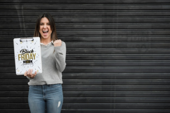 Woman holding clipboard mockup with black friday concept Free Psd