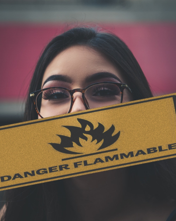 Woman Holding Danger Flammable Sign Woman Holding Danger Flammable Sign