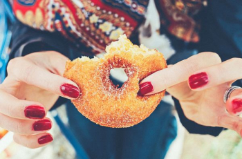 woman holding donut woman holding donut