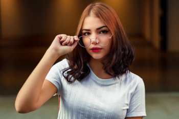 Woman Holding Eyeglasses Woman Holding Eyeglasses