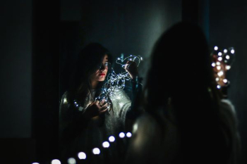 woman holding fairy lights woman holding fairy lights