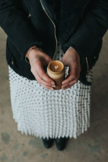 woman holding glass with brown liquid woman holding glass with brown liquid