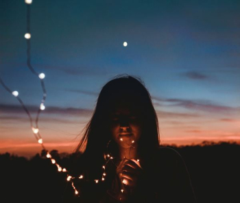 woman holding gold string lights woman holding gold string lights