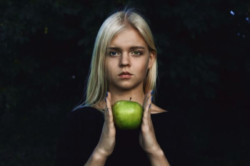 woman holding green apple woman holding green apple