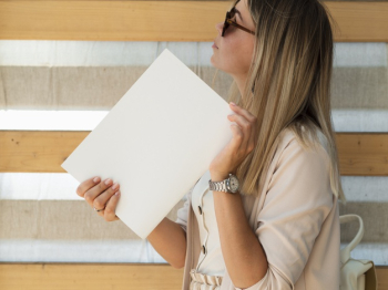 Woman holding mock-up magazine Free Photo