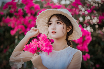 Woman Holding Pink Bougainvillea Flowers