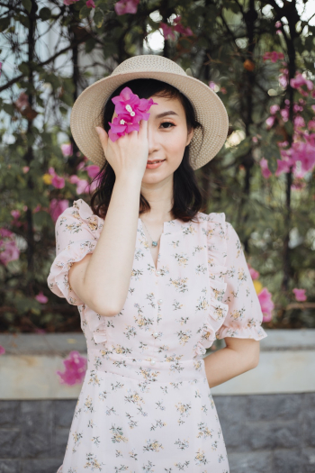 Woman Holding Pink Bougainvillea Flowers