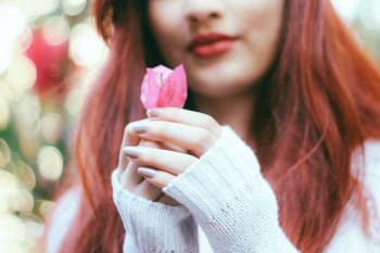 woman holding pink rose woman holding pink rose