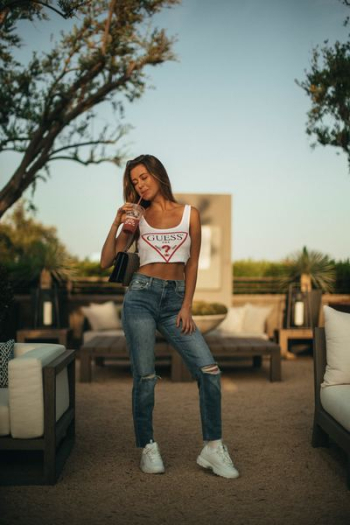 woman holding plastic cup