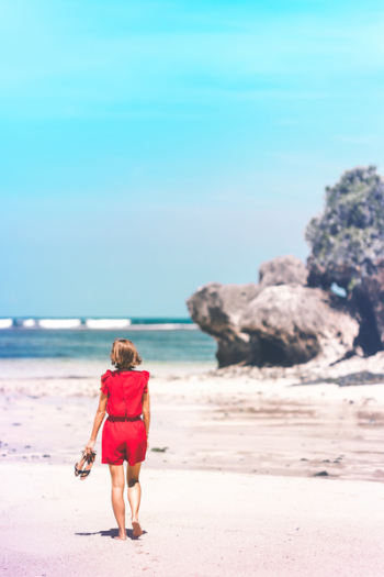 Woman Holding Sandals in the Shore Woman Holding Sandals in the Shore