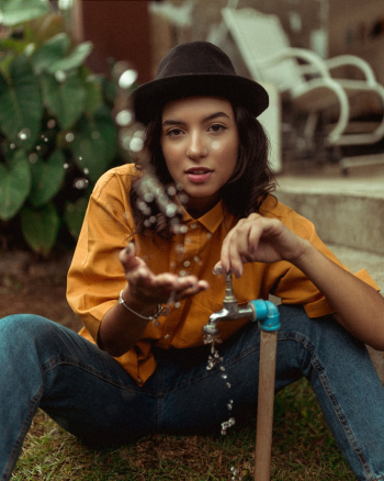Woman Holding Silver Faucet Woman Holding Silver Faucet