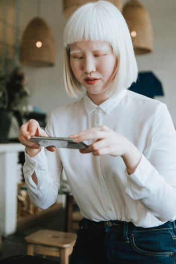 woman holding smartphone taking photo