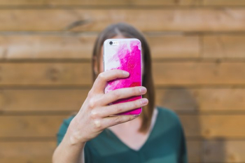 Woman Holding Up iPhone Woman Holding Up iPhone