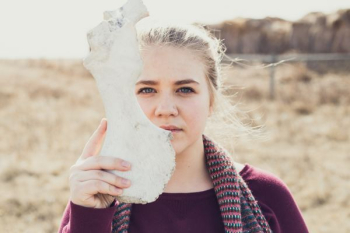 woman holding white animal bone woman holding white animal bone