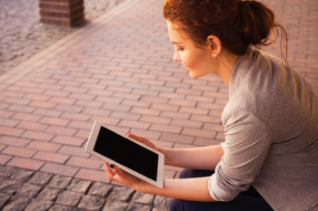 woman holding white iPad woman holding white iPad