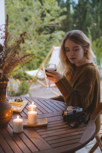 Woman Holding Wine Glass Near Table Woman Holding Wine Glass Near Table