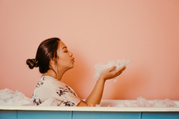 Woman In A Bath Tub Blowing Bubbles Woman In A Bath Tub Blowing Bubbles