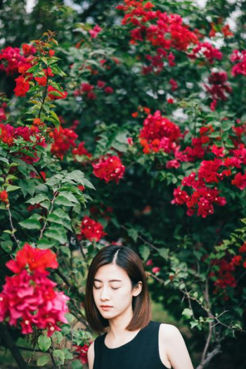 woman in black top closing her eyes