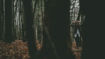 woman in blue denim pants standing on forest