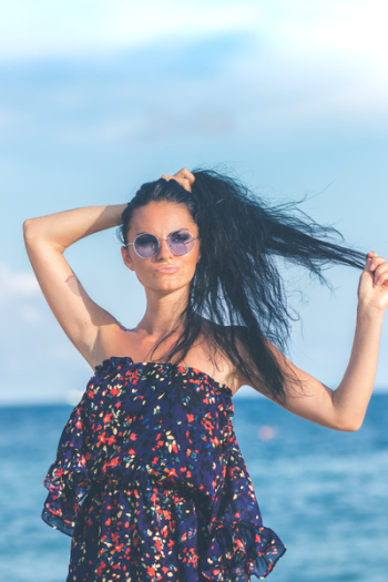 Woman in Blue Dress Standing Near Body of Water