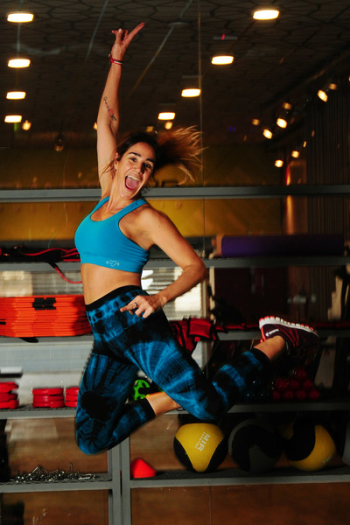 Woman in Blue Sports Bra Jumping Photo Woman in Blue Sports Bra Jumping Photo