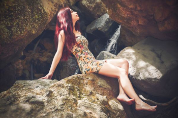 Woman in Bodycon Mini Dress Sitting on Boulder