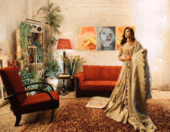 Woman in Brown Floral Sari Dress Standing Near Red Couch Woman in Brown Floral Sari Dress Standing Near Red Couch