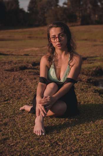 Woman in Eyeglasses Sitting on Ground Woman in Eyeglasses Sitting on Ground