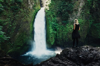 woman in front of waterfalls woman in front of waterfalls