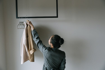 Woman in Gray Long Sleeve Shirt Holding Brown Long Sleeve Shirt Woman in Gray Long Sleeve Shirt Holding Brown Long Sleeve Shirt