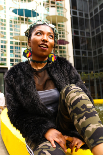 Woman in Grey Tube Top With Black Fur Coat and Green Camouflage Pants Woman in Grey Tube Top With Black Fur Coat and Green Camouflage Pants