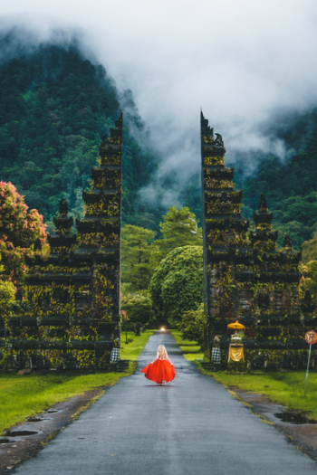 Woman in Red Dress Standing on Gray Road Woman in Red Dress Standing on Gray Road