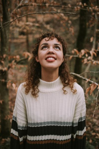 woman in white and black striped round-neck top looking up